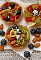 Tasty lemon desserts on table at home