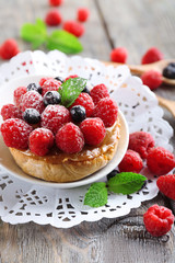 Sweet cakes with berries on table close-up