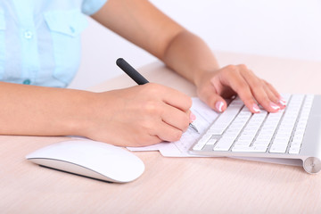 Obraz na płótnie Canvas Female hand holding computer mouse, close-up
