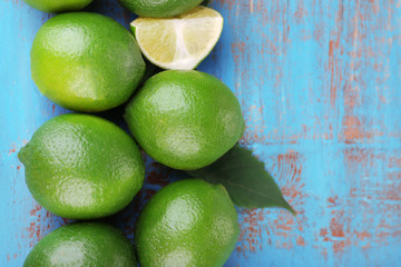 Fresh juicy limes on old wooden table