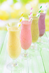 Delicious berry cocktails on table on bright background