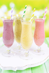 Delicious berry cocktails on table on bright background