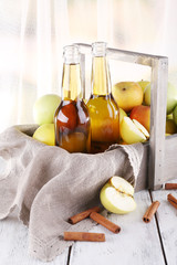 still life with apple cider and fresh apples on wooden table