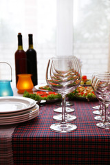 Buffet table with dishware waiting for guests