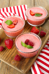 Delicious berry mousse in bowls on table close-up