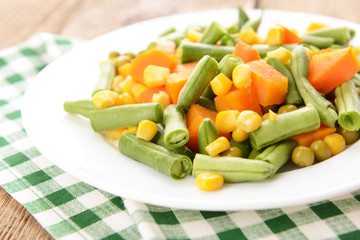 Delicious vegetables salad on plate on table close-up