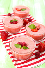 Delicious berry mousse in bowls on table close-up