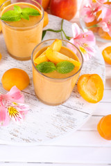 Apricot dessert in glasses on table close-up