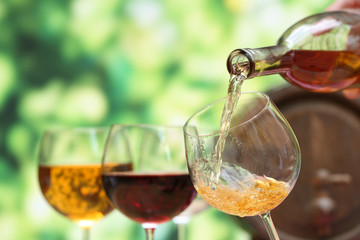 Red wine pouring into wine glass, close-up