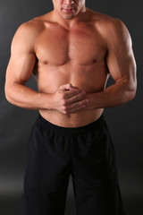 Fototapeta na wymiar Handsome muscle young man on dark background