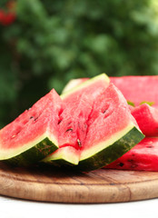 Fresh slices of watermelon on table, outdoors