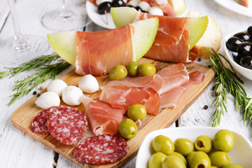 Delicious melon with prosciutto on table close-up © Africa Studio