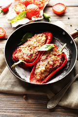 Delicious stuffed peppers in frying pan on table close-up