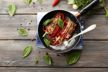 Delicious stuffed peppers in frying pan on table close-up