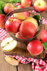 Naklejka na ściany i meble Sweet apples in wicker basket on table close-up