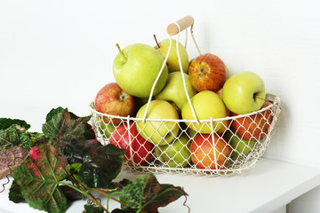 Basket of apples on white table