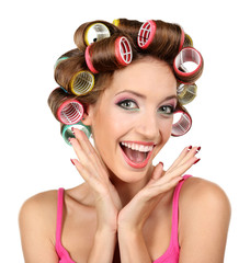 Beautiful girl in hair curlers isolated on white