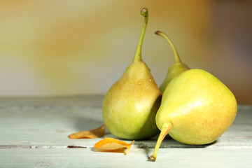 Ripe tasty pears on wooden table, on nature background
