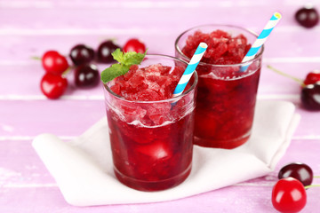 Closeup of cherry granita in glasses, on color wooden