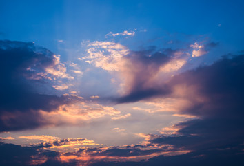 Dramatic sunset sky with orange colored clouds.