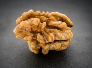 Kernel walnut on dark background. Selective focus.