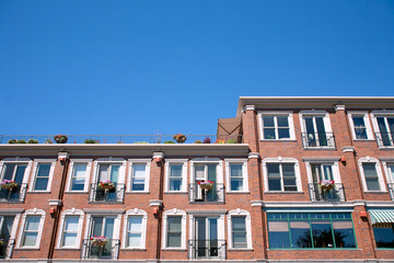 Fototapeta na wymiar red brick building facade with windows