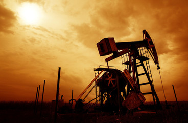 Oil and gas well silhouette in remote rural area
