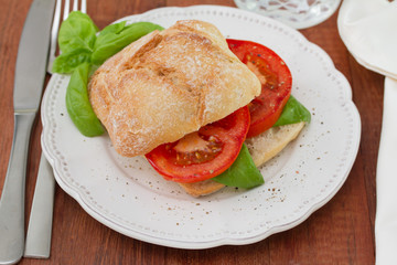 bread with tomato and basil on plate