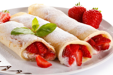 Pancakes with cream and strawberries