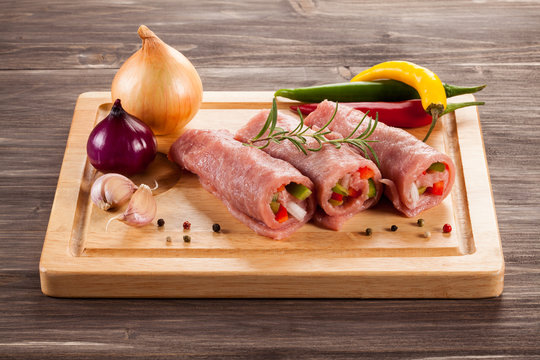 Raw Pork Chops On Cutting Board And Vegetables