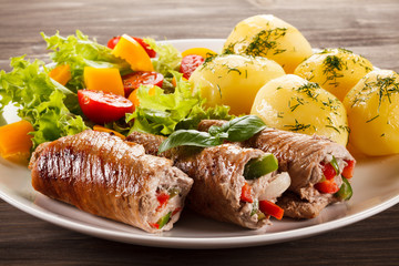 Wrapped pork chop, boiled potatoes and vegetables