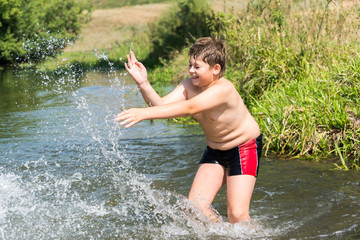 Fototapeta premium Full 10 years boy swim in river