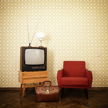 Vintage room with old fashioned armchair, retro tv, lamp and bag