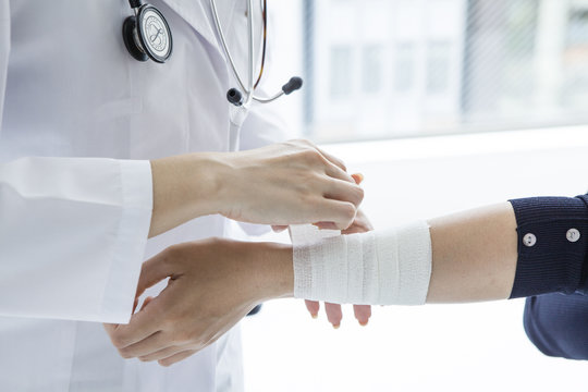 Women are wound a bandage to doctor