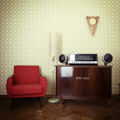 Vintage room with wallpaper, old fashioned armchair, retro playe