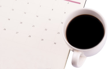 A mug of coffee and table day planner