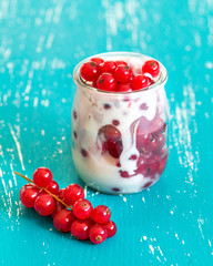Red currants and fresh yogurt in a jar