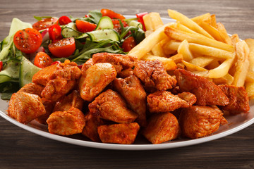 Fried chicken nuggets, French fries and vegetables