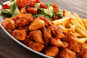 Fried chicken nuggets, French fries and vegetables