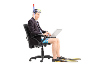 Businessman with a snorkel working on laptop © Ljupco Smokovski