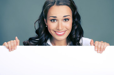 Businesswoman showing signboard, over grey