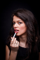 Fototapeta premium Woman applying lips