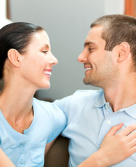 Young smiling attractive couple at home