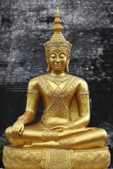 Golden Buddha statue stucco sitting meditation.