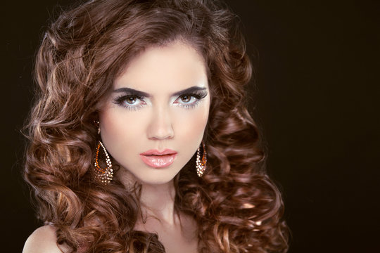 Beauty fashion girl. Wavy long hair. Brunette model with makeup