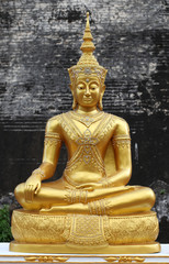 Fototapeta na wymiar Golden Buddha statue stucco sitting meditation.