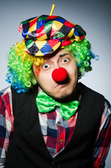 Funny clown against the dark background