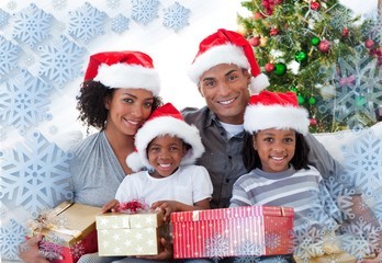 Obraz na płótnie Canvas Composite image of family holding christmas presents