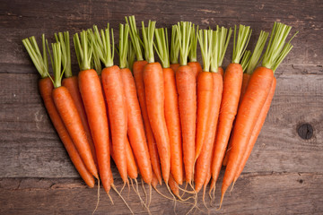 fresh carrot bunch on grungy wooden background