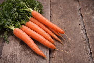 fresh carrot bunch on grungy wooden background